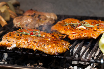 meat with  herbs grilling on barbecue