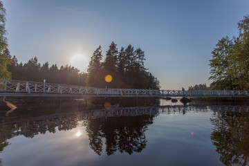 White bridges over water connecting islands are reflected in water