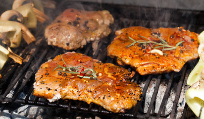 meat with  herbs grilling on barbecue