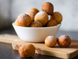 Donuts from cottage cheese, delicious dessert. Close-up. Soft focus. Donuts in Italian on a wooden board
