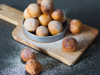 Donuts from cottage cheese, delicious dessert. Close-up. Soft focus. Donuts in Italian on a wooden board