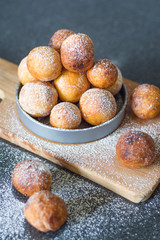 Donuts from cottage cheese, delicious dessert. Close-up. Soft focus. Donuts in Italian on a wooden board