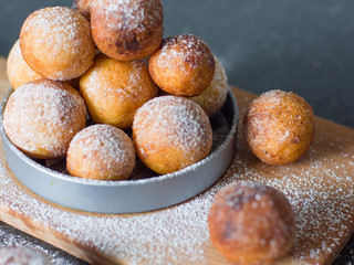 Donuts from cottage cheese, delicious dessert. Close-up. Soft focus. Donuts in Italian on a wooden board
