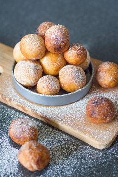 Donuts from cottage cheese, delicious dessert. Close-up. Soft focus. Donuts in Italian on a wooden board