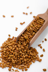 fragrant grains of fenugreek on a white background