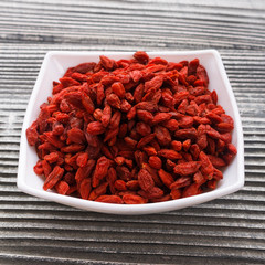 dried goji berries on a wooden rustic background