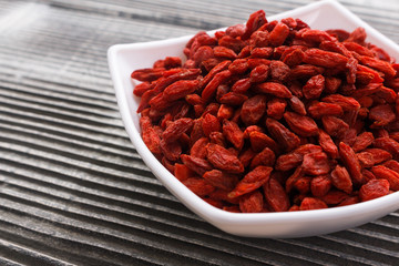 dried goji berries on a wooden rustic background