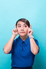 Fototapeta premium Surprised woman on isolated blue background