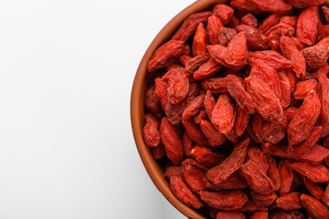dried goji berries on a white acrylic background