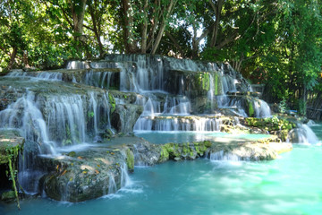 Low speed shutter or long exposure wide angle of waterfall in a forest with beautiful turquoise color of water