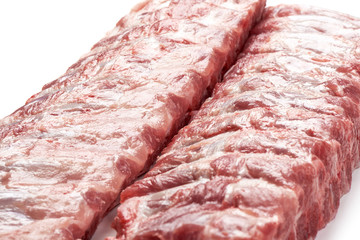 Fresh raw pork ribs, isolated on white background. Close-up.