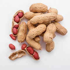 fresh peanuts on a white acrylic background