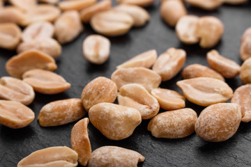 fresh peanuts on a dark stone background