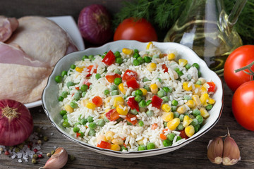 Rice with vegetables and chicken thighs for cooking .