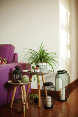 sofa in a purple, luxurious living room interior with flowers, candles and decorations