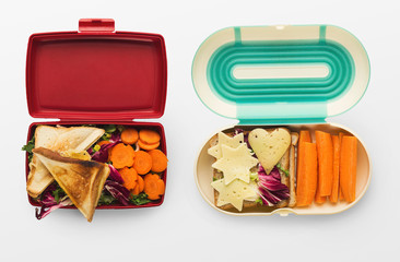 Healthy food in lunch boxes isolated on white