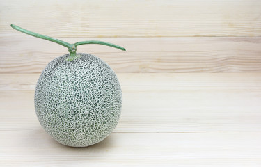 melon or cantaloupe melon with seeds  on wood background
