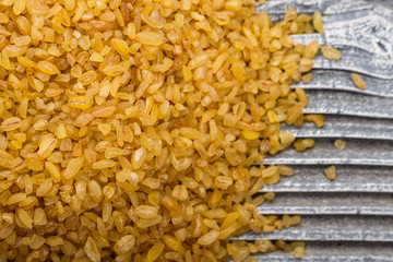 raw bulgur on a rustic wooden background