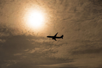 Airplane flies against a background of white cloud