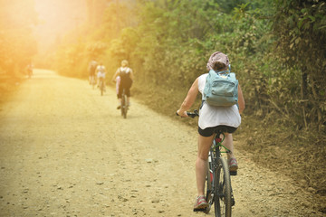 Obraz premium Tourists Cycling on a dirt road