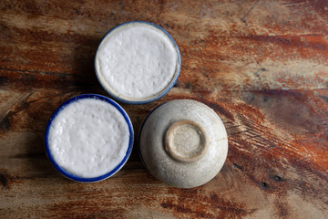 top view, khanom thuayม Thai dessert coconut milk custard in small porcelain cup .