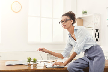 Serious business woman working on laptop at office