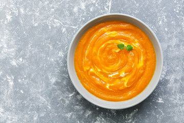 Pumpkin cream soup on a gray background, top view. A copy of the space, flat lay.