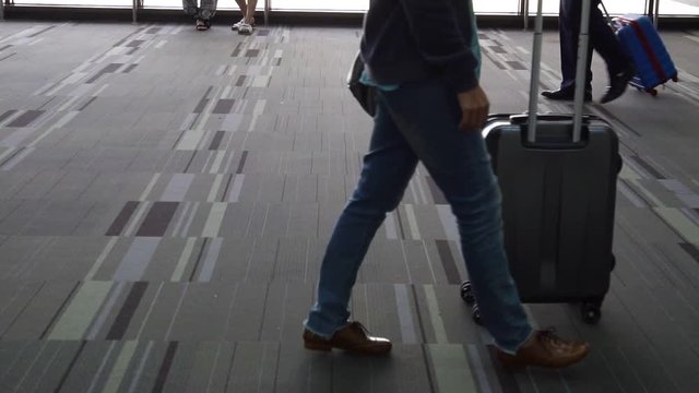 Passengers with luggage walking in the airport, Travel concept (Slow motion)