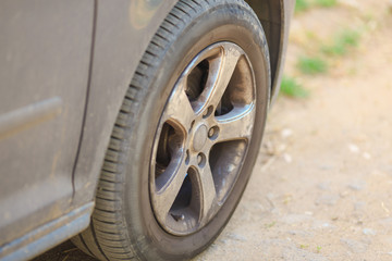 grey dirty car wheel close-up