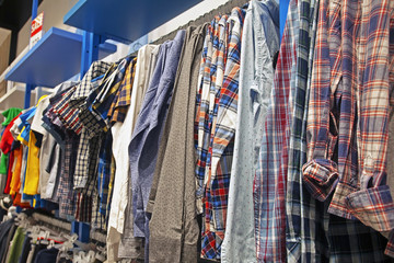 colorful bright shirts and t-shirts on hangers