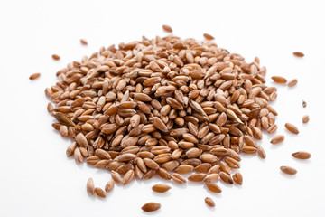 spelt seeds on a white acrylic background