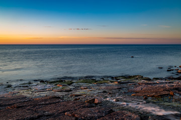 River running out on the cliffs by the sea