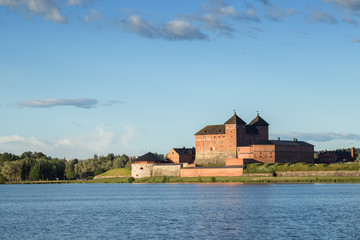 Beautiful view of the 13th century Häme Castle and lake Vanajavesi in Hämeenlinna, Finland, on a sunny day in the summer. Copy space.