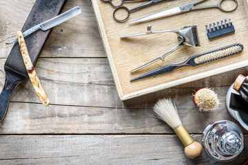 Fototapeta na wymiar Old vintage barbershop tools on wooden table - barbershop background with copy-space