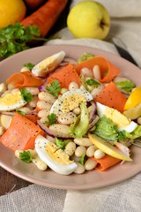 Salad with beans, egg, carrot and apple