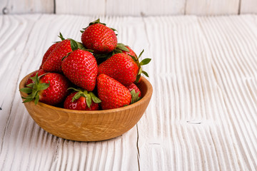 Juicy fresh strawberry on a rustic wooden background