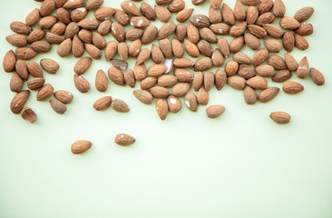 Almonds isolated on green background. Above view
