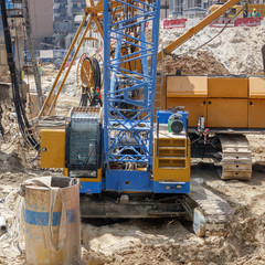 Excavator, tractor, machine for drilling wells technique for building a house.
