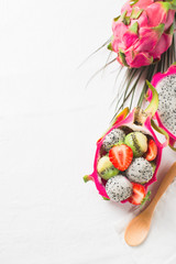 Obraz na płótnie Canvas Exotic fruit salad with pitaya, strawberry and kiwi