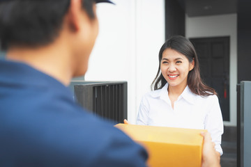 Fototapeta premium woman received package from delivery man
