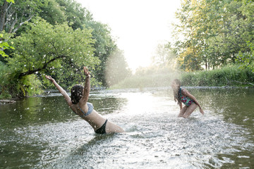 Playful friends Splashing in The river