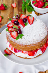 Victoria Sponge Cake with whipped cream and strawberry