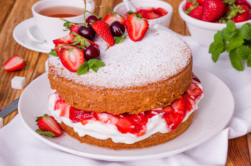 Victoria Sponge Cake with whipped cream and strawberry