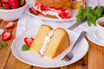 Victoria Sponge Cake with whipped cream and strawberry