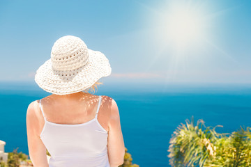 Back view of caucasian woman in white t-shirt and shawl admires beautiful view