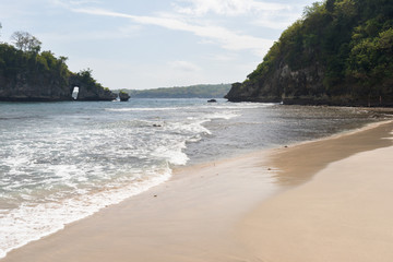 A popular beach between two rocks on the island of Nusa Penida in Indonesia