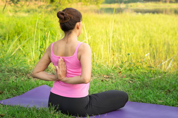 Fototapeta na wymiar female practice yoga stretching at outdoor location.