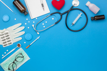 Table top view aerial image of accessories healthcare & medical background concept.Red heart & stethoscope and equipment tools on white paper.Flat lay essential items for doctor using treat patient.