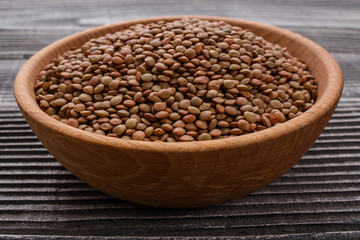 raw lentils on a wooden rustic background