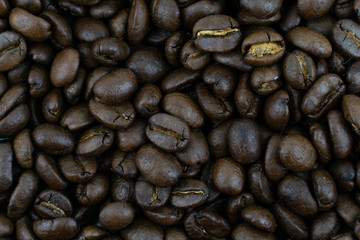 close up,pile of medium or dark roasted coffee beans. can be used as a background or graphic object in your ads.